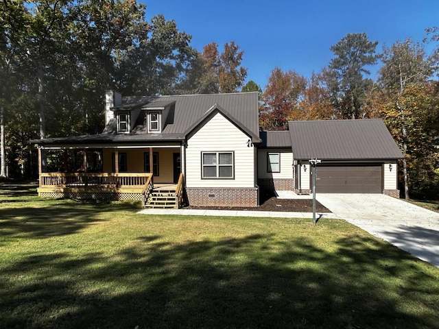 view of front of house with a garage, a front lawn, and a porch