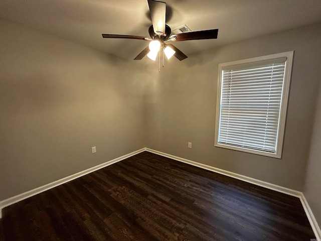 empty room featuring dark hardwood / wood-style floors and ceiling fan