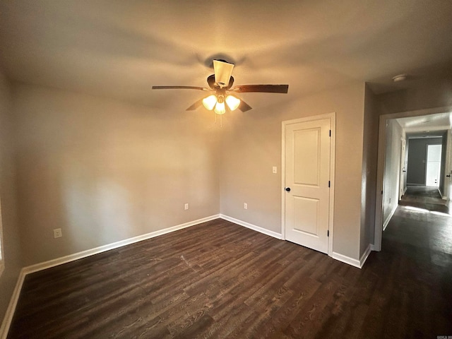 unfurnished room featuring dark wood-type flooring and ceiling fan