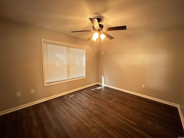 unfurnished room with dark hardwood / wood-style floors and ceiling fan