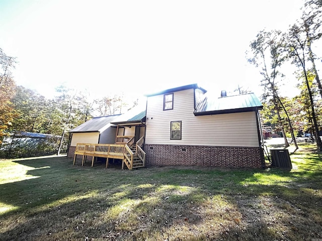 back of property with a wooden deck and a yard