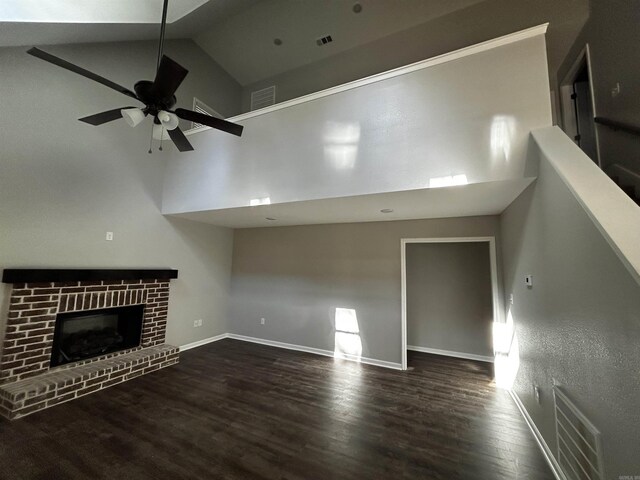 unfurnished living room with ceiling fan, a fireplace, dark hardwood / wood-style flooring, and high vaulted ceiling