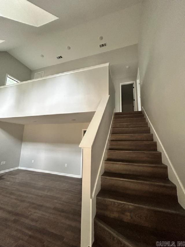 staircase featuring hardwood / wood-style flooring and a skylight