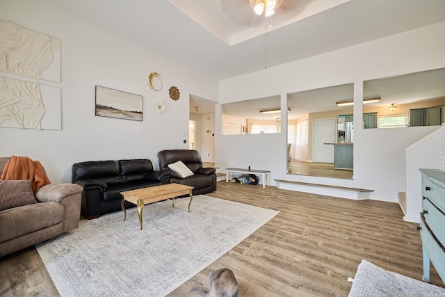 living room featuring ceiling fan and light wood-type flooring