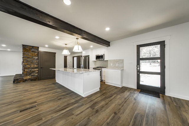 kitchen featuring sink, white cabinetry, a center island with sink, appliances with stainless steel finishes, and pendant lighting