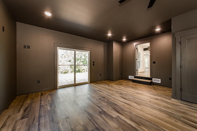 spare room with hardwood / wood-style flooring and ceiling fan