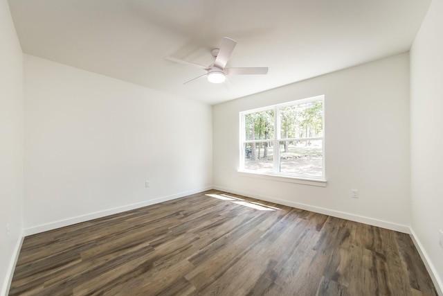 spare room with dark hardwood / wood-style floors and ceiling fan