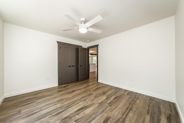 unfurnished bedroom with ceiling fan, hardwood / wood-style floors, and a closet