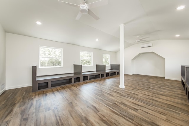 bonus room featuring vaulted ceiling, a wall unit AC, dark hardwood / wood-style floors, and ceiling fan