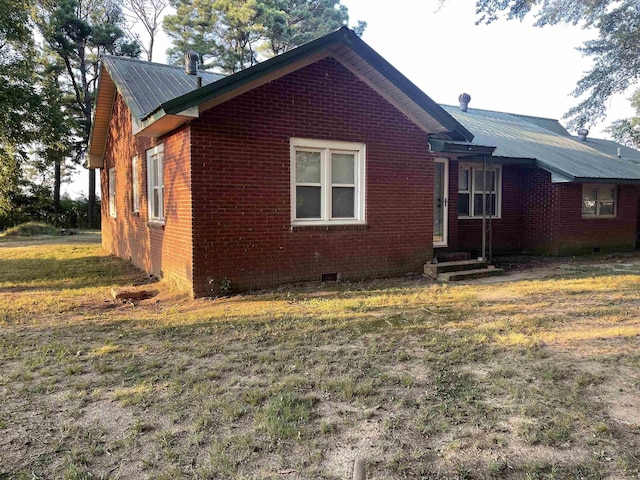 view of side of home with a yard