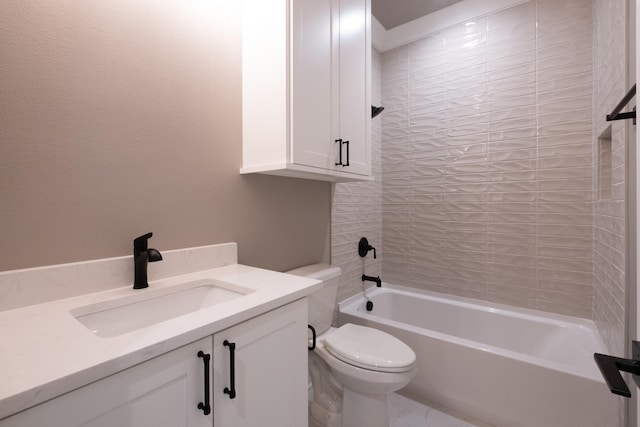 full bathroom featuring tiled shower / bath, vanity, and toilet