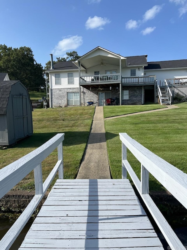 view of dock featuring a deck and a yard