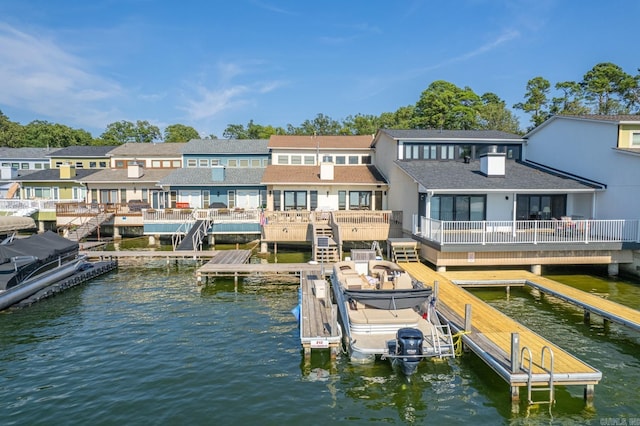 back of property featuring a deck with water view