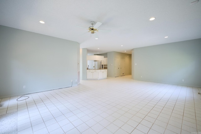 unfurnished living room with light tile patterned floors and ceiling fan