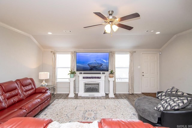 living room with ceiling fan, ornamental molding, and hardwood / wood-style flooring