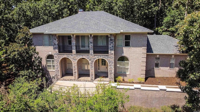 view of front of home featuring a patio area and a balcony