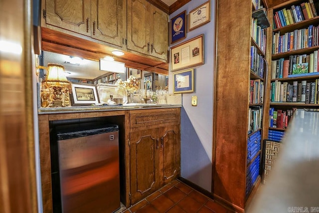 bar featuring refrigerator and dark tile patterned floors