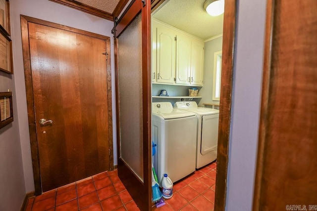 washroom featuring a textured ceiling, cabinets, light tile patterned floors, independent washer and dryer, and ornamental molding