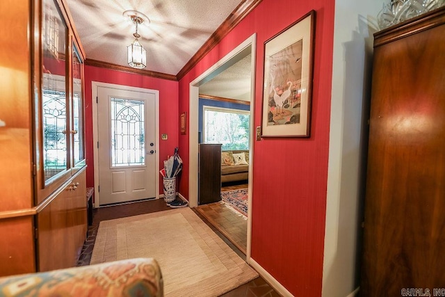 entryway featuring dark hardwood / wood-style flooring, a textured ceiling, and ornamental molding