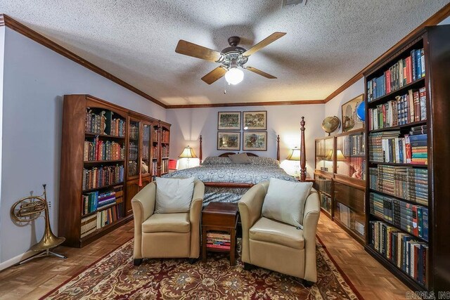 bedroom with ceiling fan, ornamental molding, a textured ceiling, and dark parquet floors