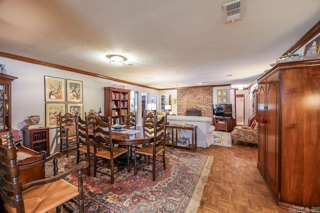 dining room with parquet flooring, a textured ceiling, and ornamental molding