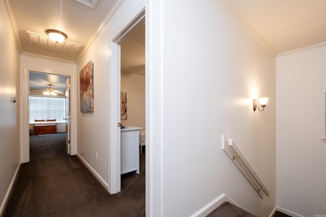 hallway with dark carpet and ornamental molding