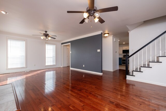 living room with hardwood / wood-style flooring, ceiling fan, crown molding, and a tiled fireplace