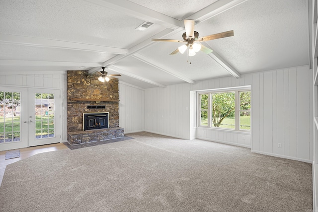 unfurnished living room with a fireplace, visible vents, lofted ceiling with beams, a ceiling fan, and a textured ceiling