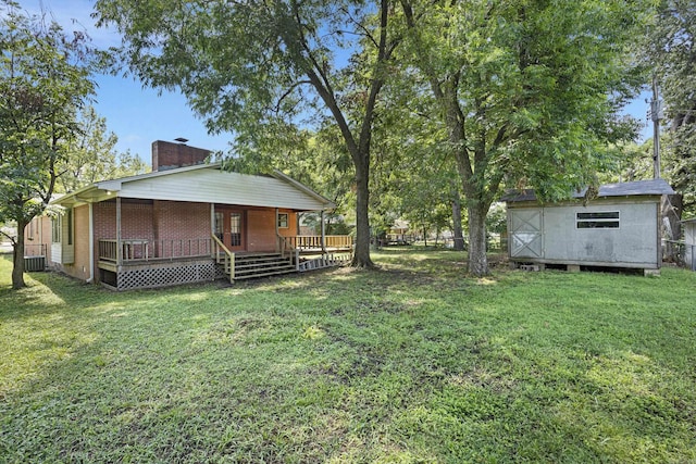 view of yard with an outbuilding, a fenced backyard, central air condition unit, a storage shed, and a wooden deck