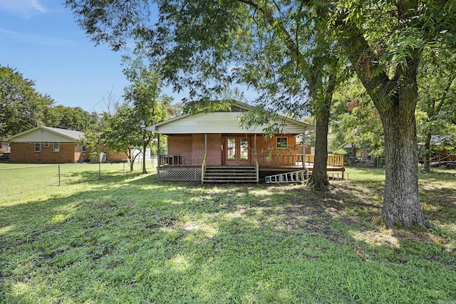 view of front of property featuring a deck, a front lawn, fence, and brick siding