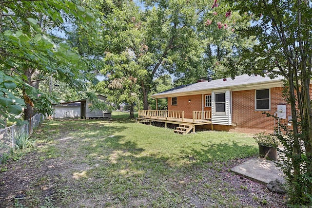 view of yard with a deck and fence