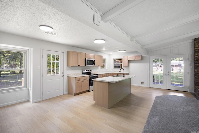 kitchen featuring french doors, light wood finished floors, visible vents, lofted ceiling with beams, and appliances with stainless steel finishes