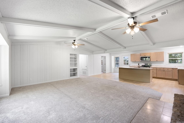 unfurnished living room with lofted ceiling with beams, a ceiling fan, visible vents, and a textured ceiling