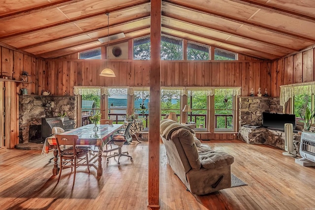 interior space featuring high vaulted ceiling, wooden walls, beam ceiling, and hardwood / wood-style floors