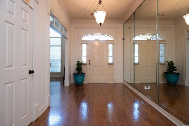 entryway featuring dark hardwood / wood-style flooring and crown molding