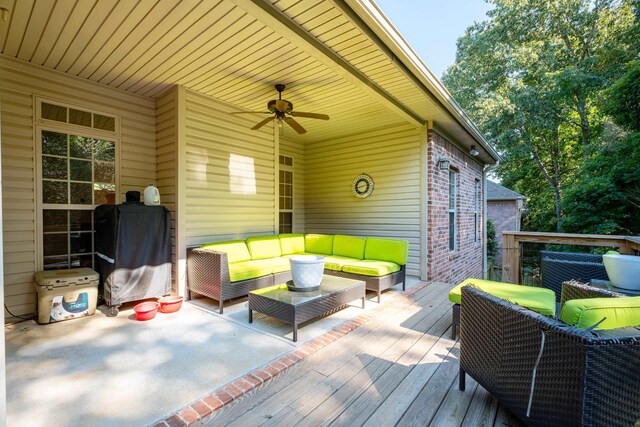 wooden terrace with ceiling fan and an outdoor hangout area