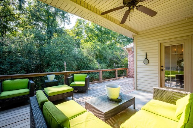 wooden deck with an outdoor hangout area and ceiling fan