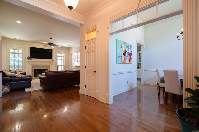 living room with ceiling fan, dark hardwood / wood-style floors, and ornamental molding