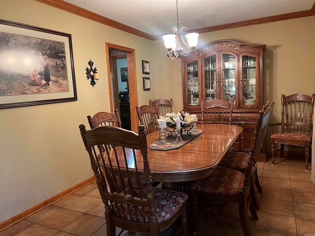 dining area with a notable chandelier, a textured ceiling, ornamental molding, and tile patterned flooring