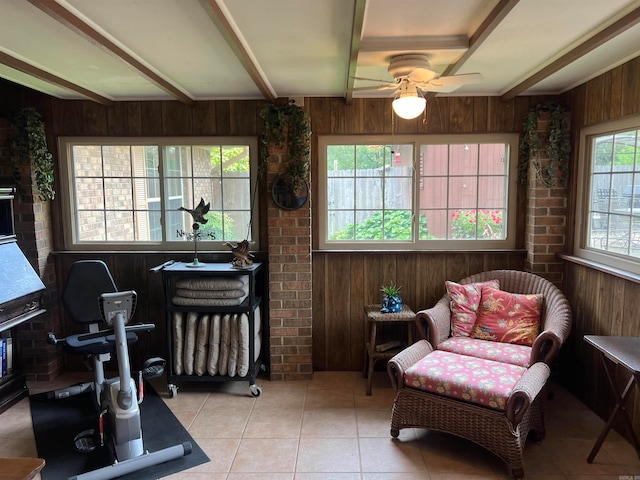 interior space featuring ceiling fan and wood walls