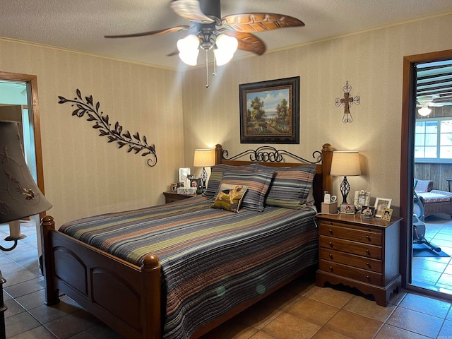 tiled bedroom with ceiling fan and a textured ceiling