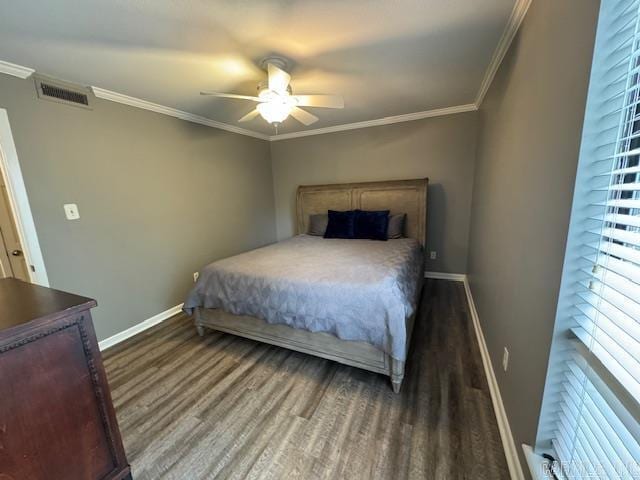 bedroom featuring crown molding, ceiling fan, and dark wood-type flooring