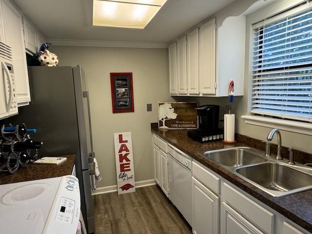 kitchen featuring dark hardwood / wood-style floors, sink, white cabinets, stove, and white dishwasher