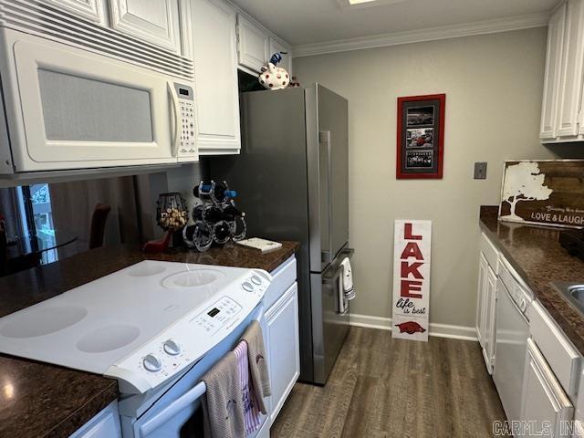 kitchen featuring dark hardwood / wood-style floors, white cabinetry, crown molding, and white appliances