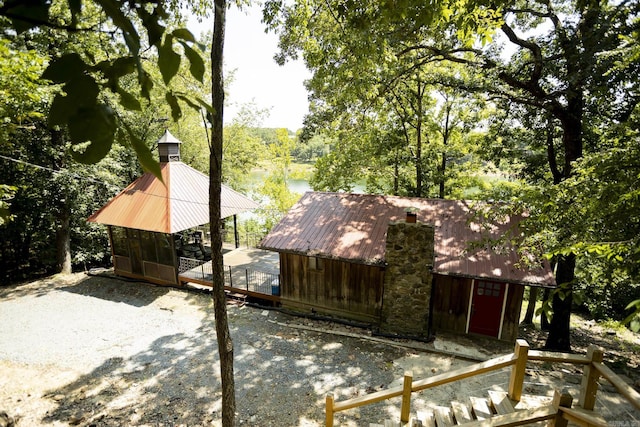 exterior space featuring a deck with water view