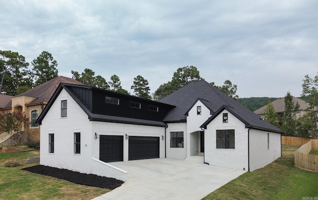 view of front of house with a garage and a front yard