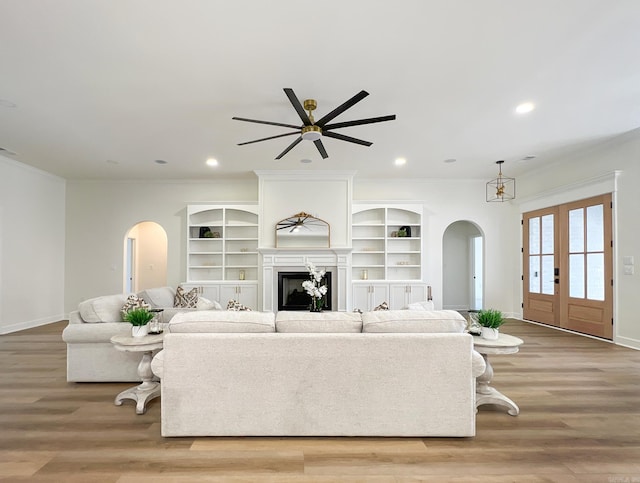 living room featuring ornamental molding and light hardwood / wood-style flooring