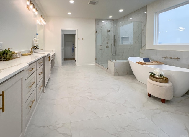 bathroom featuring vanity and separate shower and tub