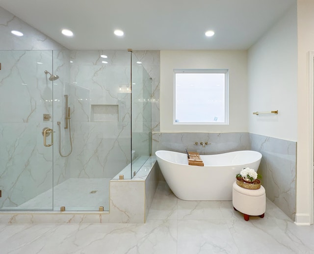 bathroom with separate shower and tub