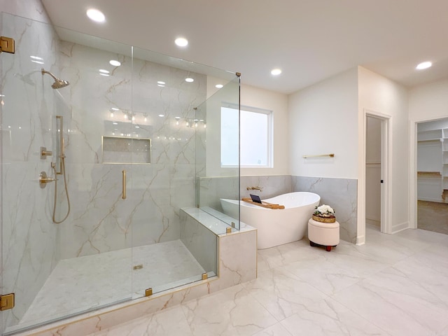 bathroom featuring shower with separate bathtub